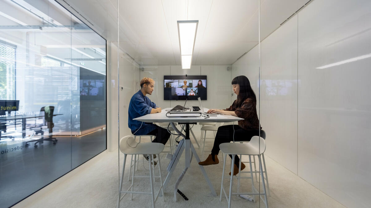 Mann und Frau arbeiten hybrid im Office Cube © Luis Alvarez / Getty Images