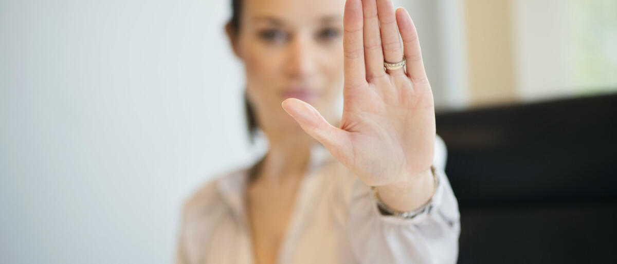 Eine Frau streckt ihre Hand abwehrend nach vorne © Eric Audras / Getty Images