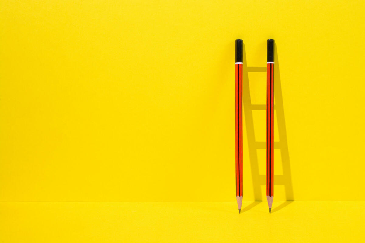 Rote Bleistifte Leiter auf gelbem Hintergrund © jayk7 / Getty Images