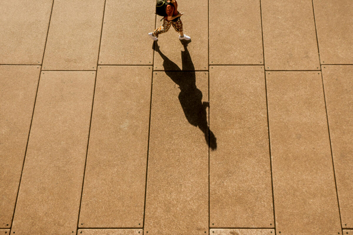 A High Angle View of a Long Shadow of a Person Walking in Sydney City © Felix Cesare / Getty Images